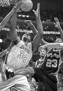 Los Angeles\' Shaquille O\'Neal (34) powers to the basket as San Antonio\'s Devin Brown (23) defends. AP Photo.