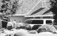 Investigators walk to the home were a man killed his 5-year-old daughter, three step children and then himself while his estranged wife was out for a morning walk in Merced, Calif., Tuesday. AP photo