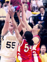 Indiana\'s Jamie Gathing (54) and Jill Chapman harass Purdue\'s Mary Jo Noon during Sunday\'s Big Ten Women\'s Tournament semifinal at Conseco Fieldhouse in Indianapolis. Indiana beat the top-seeded Boilermakers, 55-41. Staff photo by Rich Janzaruk