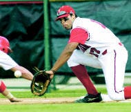 Indiana\'s Gibran Hamdan fields a pick-off throw at first base during Friday\'s game against Ohio State. Hamdan later quarterbacked the Crimson team at Memorial Stadium. Staff photo by David Snodgress