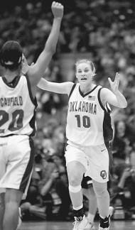 Oklahoma\'s Caton Hill (10) and LaNeishea Caufield celebrate Hill\'s second-half 3-pointer in the Sooners\' 86-71 win over Duke. AP photo