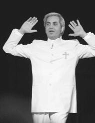 Evangelist Benny Hinn raises his hands during a service at the Blaisdell Concert Hall in Honolulu, Hawaii, Jan. 11. While other TV evangelists like Jimmy Swaggart, Jim Bakker and Robert Tilton have fallen from grace over the past two decades, Hinn plows ahead, relentlessly seeking souls and money. AP photo