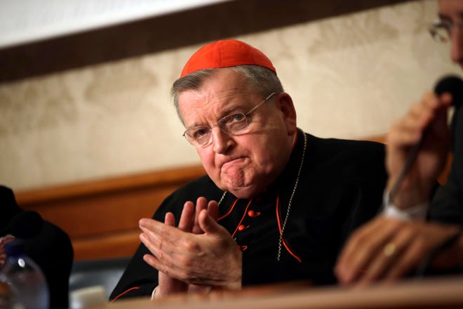Cardinal Raymond Burke applauds during a press conference at the Italian Senate in Rome in 2018.