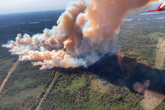 A rapidly growing wildfire spews smoke in northeastern Minnesota on Monday. The blaze was spotted about 3 p.m. Sunday near Greenwood Lake, about 15 miles southwest of Isabella, in the Superior National Forest.