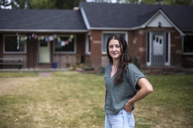 Sara Dery, who was born in Jackson, Wyo., stands in the front yard of her home Aug. 2 in Jackson. Dery recently found out that her rental home and the home and commercial building on the adjacent lots near East Kelly Avenue and Vine Street are being sold for $14 million.