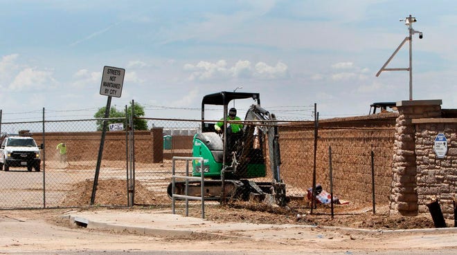 Workers prepare land for construction of new homes at the Tuscany subdivision in Casa Grande, Ariz., on July 30.