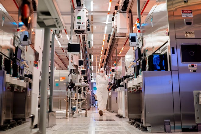An Intel employee walks through a fabrication plant.