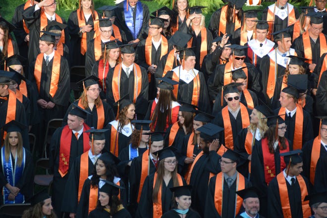 Somerset Area High School 2019 graduates stand during the opening of a ceremony Thursday at the school athletic field. The class consists of 189 graduates. See more photos.