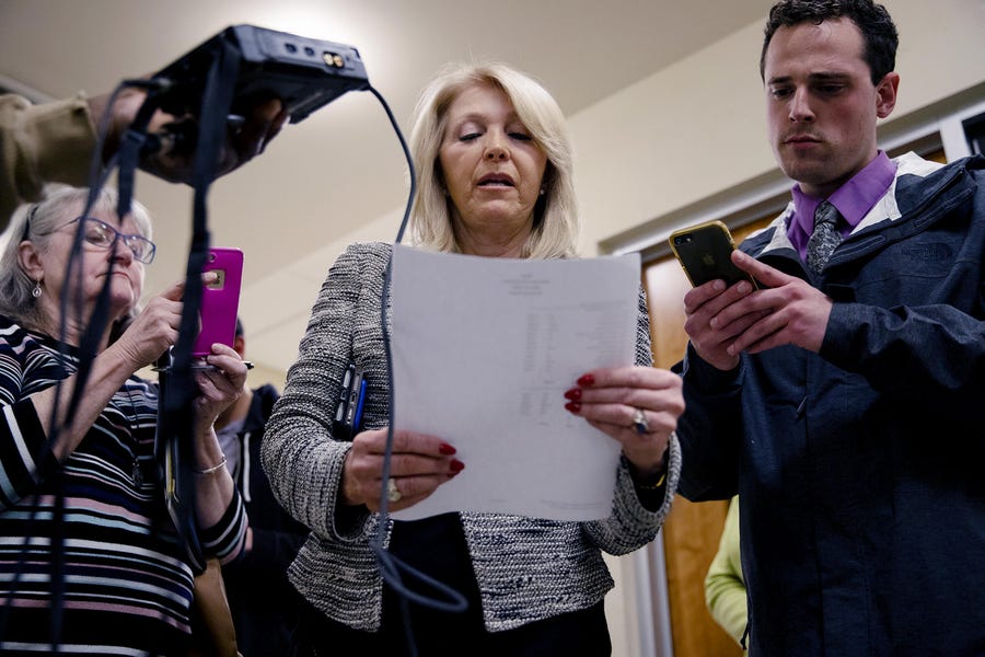 Mesa County Clerk Tina Peters, center, reads the results from the first round of ballots for the 2020 presidential primary elections at the Mesa County election office in Grand Junction, Colo., on March 3, 2020. The county's election equipment has been decertified and will have to be replaced following a security breach allegedly aided by Peters.