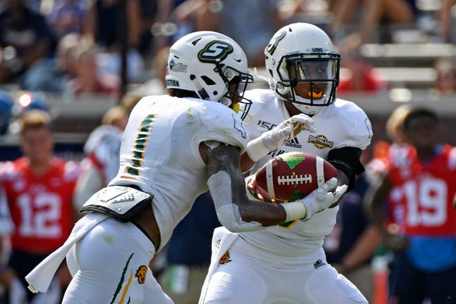 Southeastern Louisiana quarterback Chason Virgil (9) hands the ball off to running back Devonte Williams (1) during the first half of an NCAA college football game against Mississippi in Oxford, Miss., Saturday, Sept. 14, 2019.