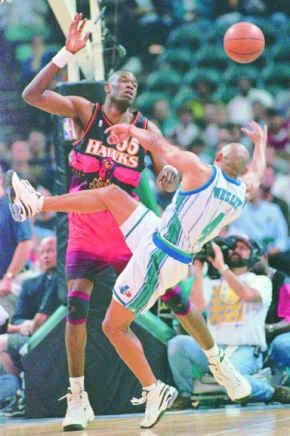 Charlotte\'s David Wesley and Atlanta\'s Dikembe Mutombo collide during the team\'s opening game of the best-of-five series Thursday night. The Hornets won 97-87, taking a 1-0 lead in the series. AP photo