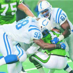 New York quarterback Neil O\'Donnell is mauled by Indianapolis\' Dan Footman, left, and Tony McCoy (61) during the Colts\' 22-14 win over the Jets Sunday. AP Photo