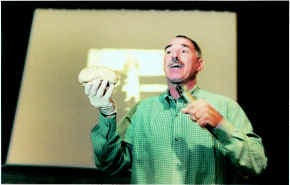 Victor DeNoble, a former researcher for Philip Morris, holds up half a human brain while telling seventh-graders at Tri-North Middle School how nicotine changes the brain in rats, monkeys and humans. Staff photo by Jeremy Hogan