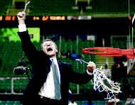 Michigan State coach Tom Izzo celebrates after cutting down the net following Sundays 69-62 win over Temple in the South Regional final in Atlanta. AP photo
