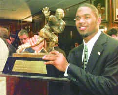 Michigan\'s Charles Woodson shows off his Heisman Trophy. AP photo