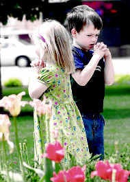 Erika Mathey, 4, and Kyle Bryo, 6, both of Sycamore, Ill., participate in the National Day of Prayer gathering at the DeKalb County Courthouse Thursday. AP photo