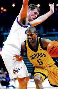 Indianas Jalen Rose drives against Washingtons Christian Laettner during Tuesday nights 110-102 Pacer win. Photo