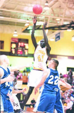 North\'s Kueth Duany shoots over Franklin Central\'s Nick Herzog (left) and Mark Mitchel (22) during Saturday night\'s game at North. Duany had 34 points in the Cougars\' 69-33. Staff photo by Mark Hume