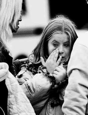 Erica Secosky, 9, wipes tears away from her eyes at the Pleasant Manor housing complex in Mount Pleasant, Pa., where Jeremy Barnhart, also 9, was shot to death Saturday. Erica said Jeremy was her best friend. State police say Alan Waterhouse shot Jeremy and his 14-year-old sister, Cori Barnhart, and held police at bay for nearly 12 hours before shooting himself. Waterhouse had dated the children\'s mother. Cori was in critical condition at a Pittsburgh hospital. AP PHOTO