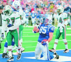 Indianapolis tight end Ken Dilger celebrates in the end zone after the second of his three TD catches during the Colts\' 41-0 win over the Miami Dolphins on Sunday at the RCA Doma. The Dolphins are Terrell Buckley (27) and Jerry Wilson (24). AT Photo