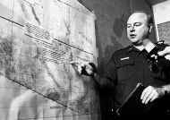 Mark Haynes, assistant chief of the U.S. Border Patrol\'s Yuma, Ariz. station, shown Thursday in Yuma, points to areas on a map where Border Patrol agents found a g,roup of Mexican migrants. The migrants were seeking to enter the United States illegally through the southern Arizona desert earlier this week. Fourteen Mexican citizens who went on the journey died from dehydration and exposure, officials said. AP photo