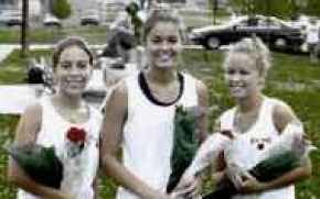 Senior Smiles - Coach Ken Barrett honored his three senior members on this year\'s girls tennis team prior to yesterday\'s match. The class of 2001 includes (L to R) Lindsey Jones, Nicole Nonte and Laura Lee.