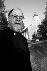 The Rev. Samuel Edwards stands in front of Christ Church of St. Johns Parish, an Episcopal church in Accokeek, Md., April 26. Edwards, whose writings refer to the Episcopal Church as the Unchurch, is at the center of controversy between the church that recently hired him and the leaders of the Episcopal Diocese of Washington. AP photo