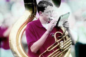 Brownstown Central band member David Ollis, of Brownstown, braved the steady rain while playing his tuba during the half-time show of the Indiana University and Wisconsin football game Saturday afternoon. Staff photo by Chris Howell