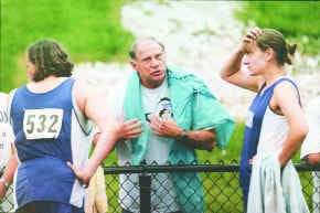 South throwing coach Bob Whitlow talks to shot putters Rachel Cazee (left) and Amanda Horvath during Tuesday night\'s track regional at Bedford. Horvath finished second and Cazee third, while North won the team title. Staff photo by Chris Howell
