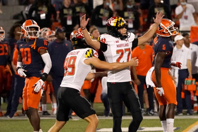 Maryland's Joseph Petrino celebrates his game-winning field goal with holder Colton Spangler during the second half of the team's NCAA college football game against Illinois on Friday, Sept. 17, 2021, in Champaign, Ill. Maryland won 20-17. (AP Photo/Charles Rex Arbogast)