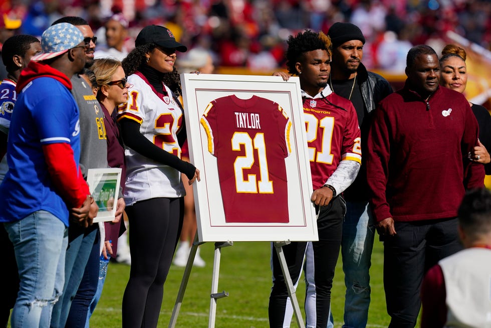 Family members of the late Sean Taylor gather on the field as the Washington Football Team retire his jersey during a halftime ceremony at an NFL football game against the Kansas City Chiefs, Sunday, Oct. 17, 2021, in Landover, Md. (AP Photo/Patrick Semansky)