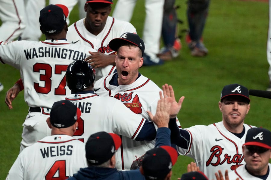 Atlanta Braves relief pitcher Will Smith, center, celebrates their win in Game 4 of baseball's World Series between the Houston Astros and the Atlanta Braves Saturday, Oct. 30, 2021, in Atlanta. The Braves won 3-2, to lead the series 3-1 games. (AP Photo/Brynn Anderson)