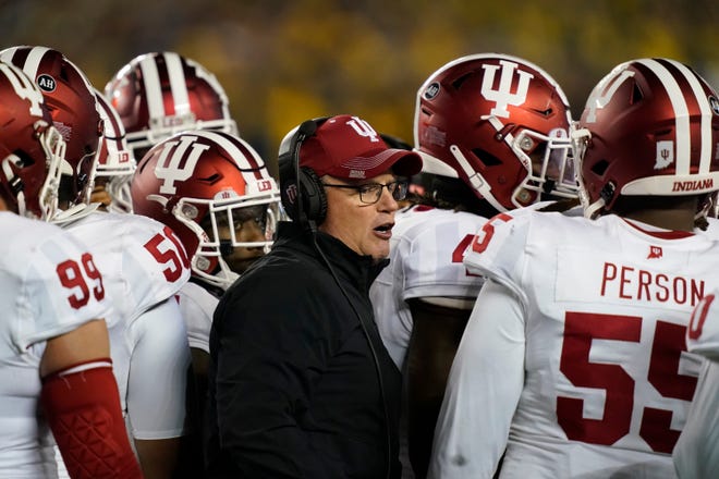 Indiana head coach Tom Allen stands next to his team during the first half of an NCAA college football game against Michigan, Saturday, Nov. 6, 2021, in Ann Arbor, Michigan (AP Photo/Carlos Osorio)