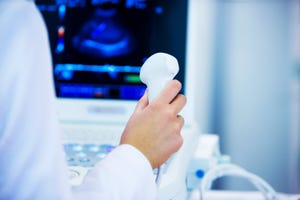 A person holding an ultrasound device.