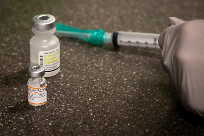 A vial of the Pfizer pediatric COVID-19 vaccine and a diluent for it are seen on the first day of a clinic with the University of Iowa Hospitals & Clinics on Nov. 3 at the University of Iowa Health Care Iowa River Landing location in Coralville, Iowa.