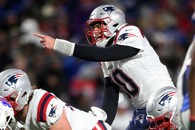 New England Patriots quarterback Mac Jones (10) calls signals during the second half of an NFL football game against the Buffalo Bills in Orchard Park, N.Y., Monday, Dec. 6, 2021. (AP Photo/Joshua Bessex)