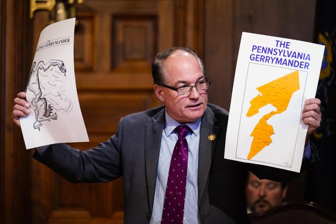 House Majority Leader Kerry Benninghoff, R-Centre, holds up maps Thursday during a meeting of the Pennsylvania Legislative Reapportionment Commission at the Capitol in Harrisburg.