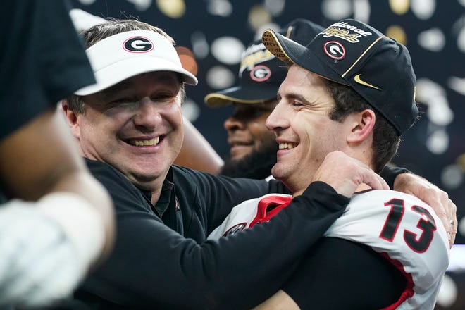 Georgia head coach Kirby Smart celebrates with Stetson Bennett after the College Football Playoff championship football game against Alabama Tuesday, Jan. 11, 2022, in Indianapolis. Georgia won 33-18. (AP Photo/Darron Cummings)