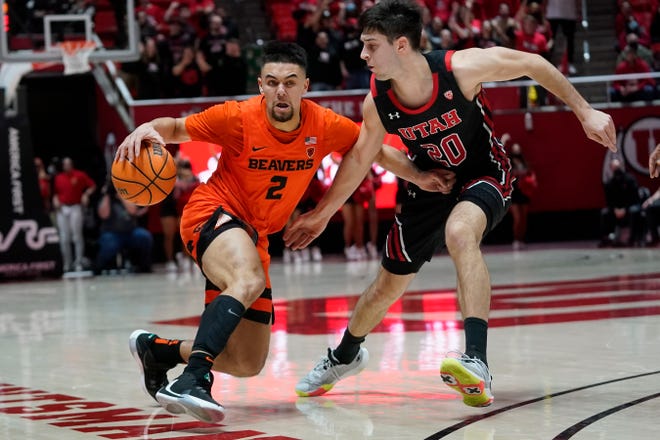 Utah's Lazar Stefanovic (20) guards against Oregon State's Jarod Lucas (2) during the teams' Pac-12 game on Feb. 3.