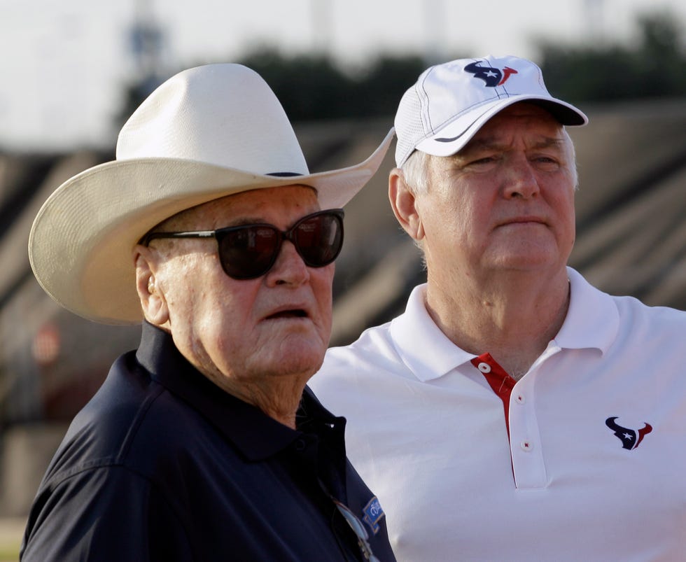 Former Houston Texans defensive coordinator Wade Phillips, right, and his father, Bum Phillips before an NFL football training camp practice Aug. 3, 2011, in Houston. Bum lost two AFC championship games as head coach of the Houston Oilers. His son Wade coached 42 years in the NFL as both a head coach and longtime defensive coordinator, reaching three Super Bowls and winning only one. (AP Photo/David J. Phillip)