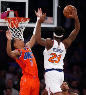 New York Knicks' Mitchell Robinson (23) shoots over Oklahoma City Thunder's Darius Bazley (7) during the first half of an NBA basketball game Monday, Feb. 14, 2022, in New York. (AP Photo/John Munson)