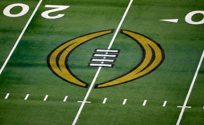 The College Football Playoff logo is shown on the field at AT&T Stadium before an NCAA college football game in Arlington, Texas, Jan. 1, 2021.