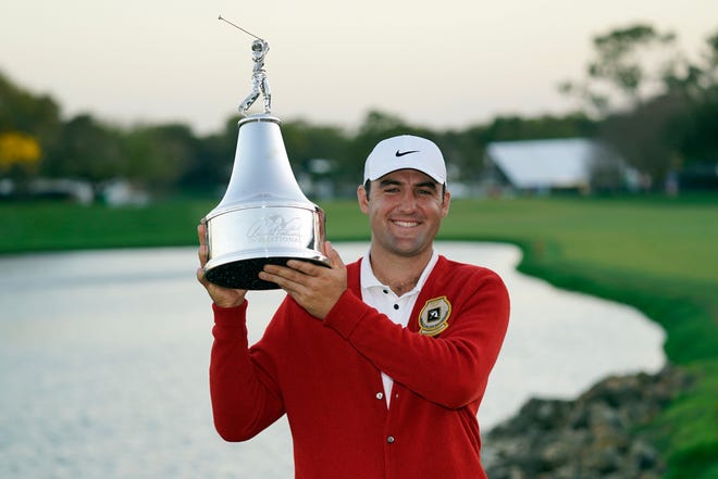 Scottie Scheffler holds up the championship trophy after winning the Arnold Palmer Invitational golf tournament Sunday. The Texas ex shot a 72 in the final round for a 5-under 283, one stroke better than Viktor Hovland, Tyrrell Hatton and Billy Horschel.