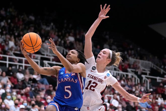 Kansas guard Aniya Thomas (5) drives to the basket against Stanford guard Lexie Hull (12) during the second half of a second-round game in the NCAA women's college basketball tournament Sunday, March 20, 2022, in Stanford, Calif. (AP Photo/Tony Avelar)