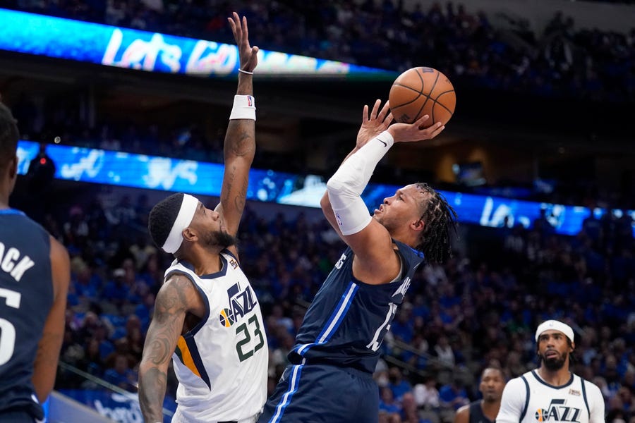 Utah Jazz forward Royce O'Neale (23) defends against a shot by Dallas Mavericks' Jalen Brunson (13) in the second half of Game 1 of an NBA basketball first-round playoff series, Saturday, April 16, 2022, in Dallas. (AP Photo/Tony Gutierrez)