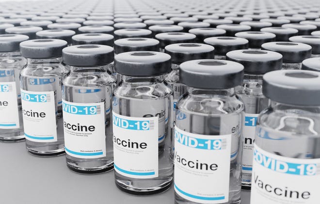 Vials labeled COVID-19 vaccine.