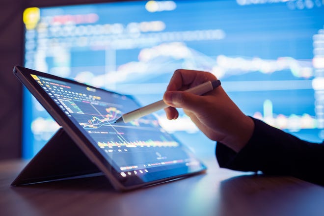 Woman searching stock market data on smartphone