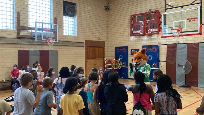 Tricky the fox, mascot for Pocono Raceway, visits the Pocono Family YMCA in Stroudsburg on Monday to kick off race week by delivering materials for more than 100 children to participate in the NASCAR Foundation’s weeklong Speediatrics Fun Day Festival.