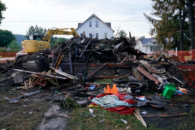 A house that was destroyed by a fatal fire is viewed in Nescopeck, Pa., Friday, Aug. 5, 2022. Multiple people are feared dead after the fire early Friday in northeastern Pennsylvania, according to a volunteer firefighter who responded and said the victims were his relatives. A criminal investigation is underway, police said. (AP Photo/Matt Rourke)