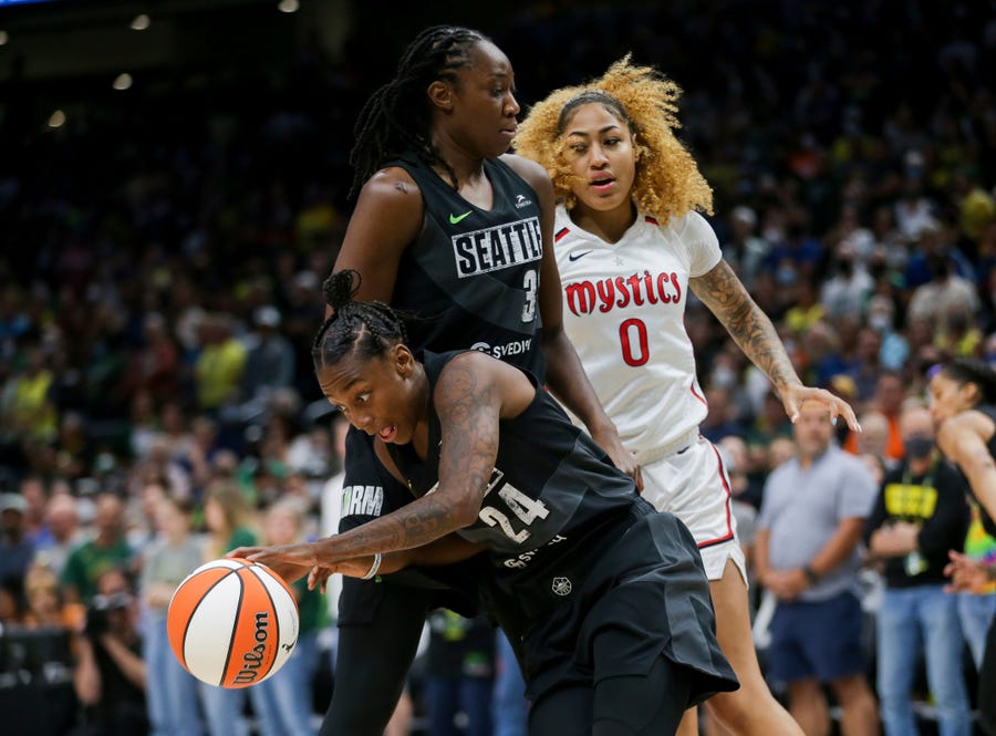 Seattle Storm guard Jewell Loyd (24) gets the rebound and makes a break around Storm center Tina Charles (31) as Washington Mystics center Shakira Austin (0) watches during the first half of Game 1 of a WNBA basketball first-round playoff series Thursday, Aug. 18, 2022, in Seattle. (AP Photo/Lindsey Wasson)